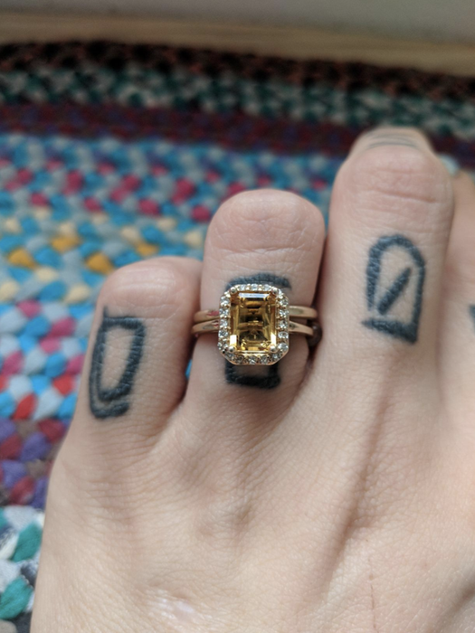 The same reviewer showing off their ring after using the cleaning pen, now sparkling and nearly clear.