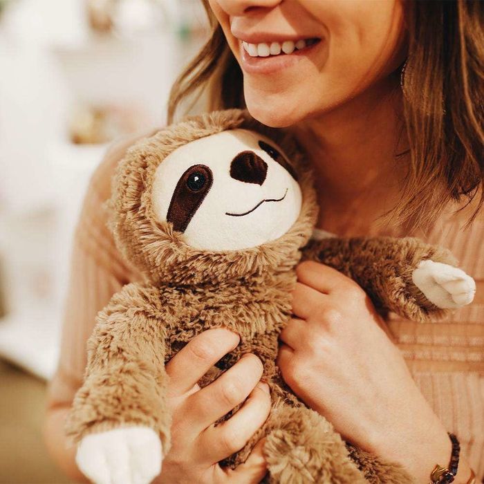 a model holding an incredibly soft plush sloth