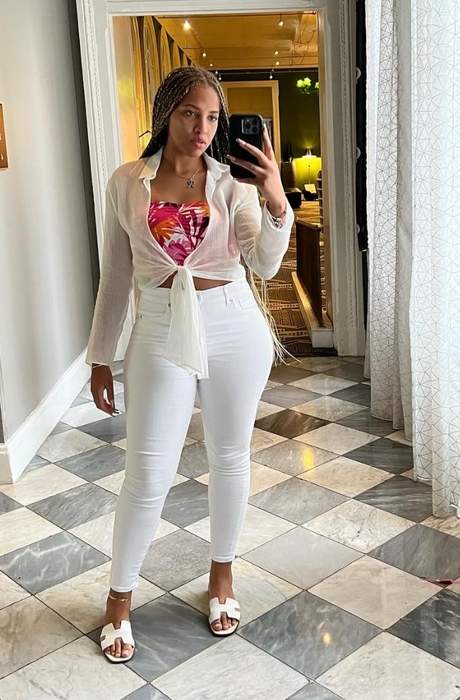 A reviewer wearing the sandals in white.