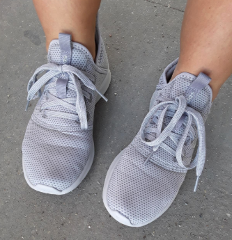 a reviewer wearing soft lavender sneakers