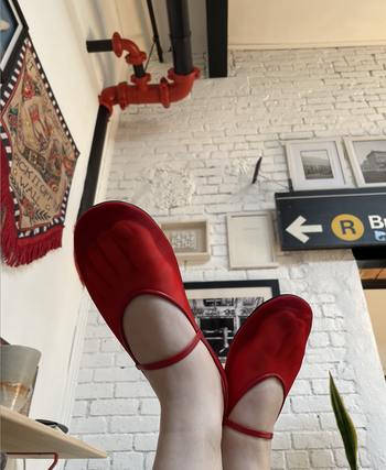 Close-up shot of feet in mesh Mary Jane flats