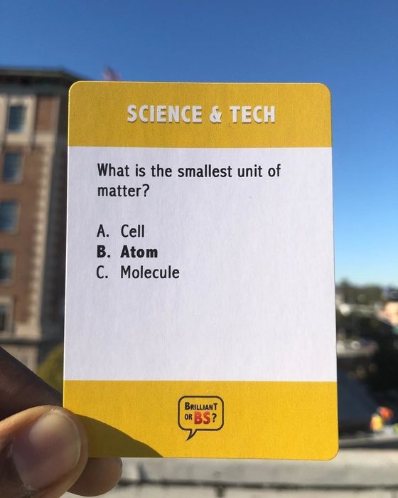 A person holding up a game question card.