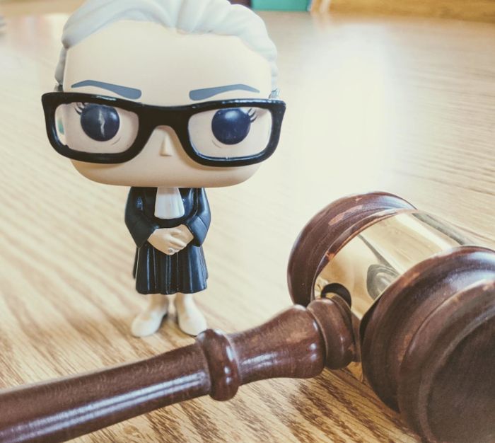 the Funko Pop figure displayed beside a gavel