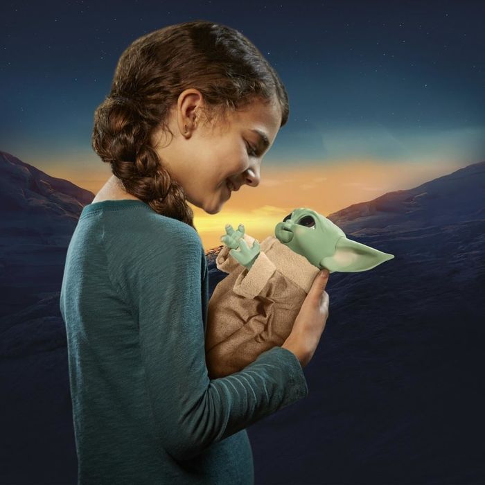 a child holding the doll with its arms raised