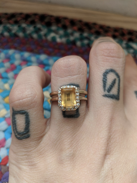 A close-up of a reviewer's yellow diamond ring, slightly cloudy and in need of a good cleaning to restore its brilliance.