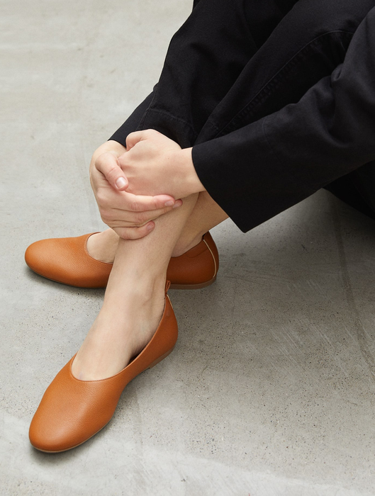 Another model showcasing the toasted almond-colored flats.