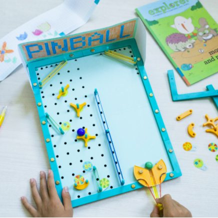 hands engaging with the compact, tabletop-sized game