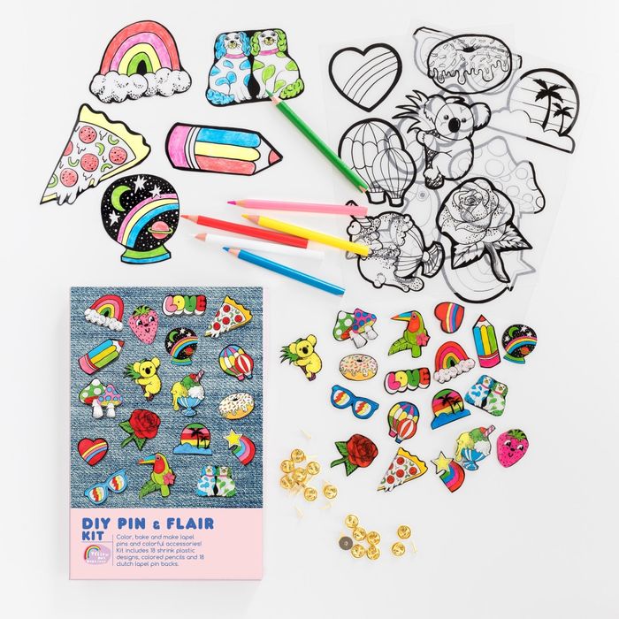 the kit includes colored pencils and designs featuring sunglasses, a rainbow, a crystal ball, pizza, a pencil, a heart, a rose, and hot air balloons