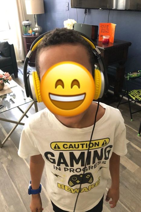 a child wearing black and yellow corded headphones