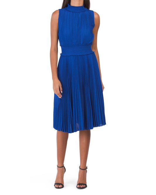 model showcasing the blue pleated high-neck dress