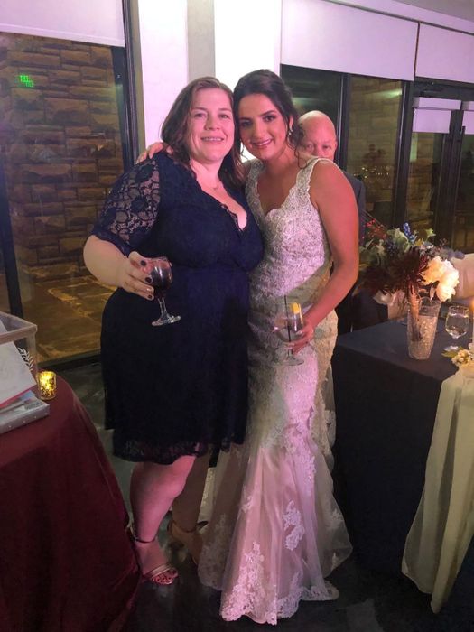 a reviewer wearing the navy blue version of the dress