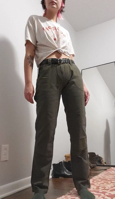 a reviewer modeling the green carpenter pants