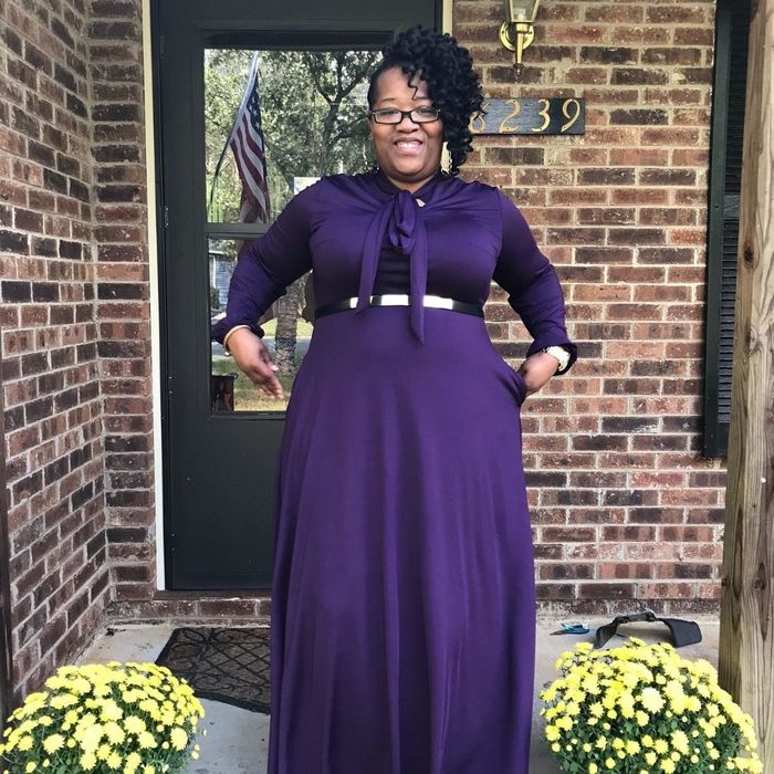 Another reviewer wearing the purple dress with a belt