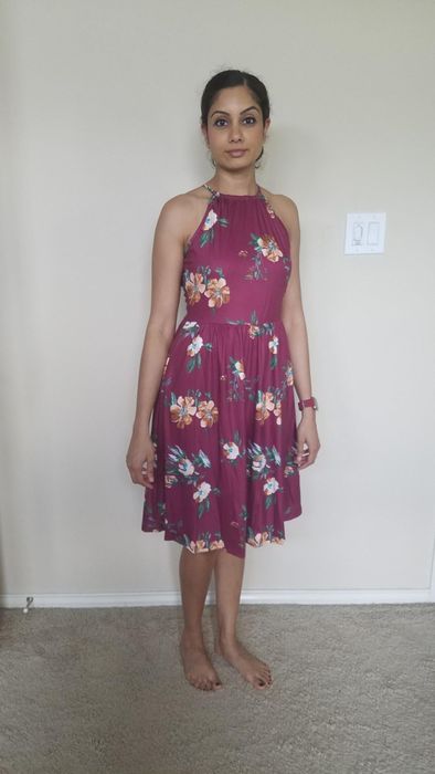Reviewer in a floral dress