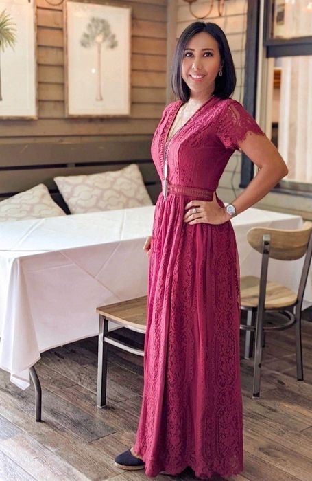 a reviewer wearing the red version of the dress