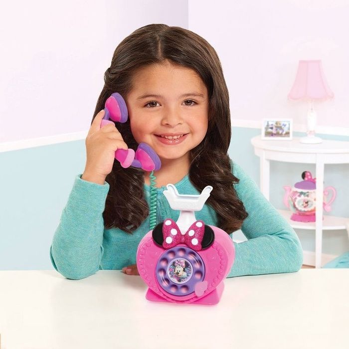 Child talking on a Minnie Mouse phone