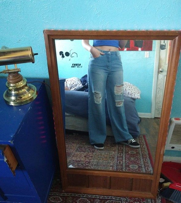 a reviewer showcasing the light wash jeans