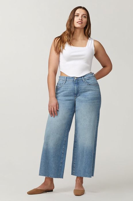 A model styling wide-leg blue jeans.