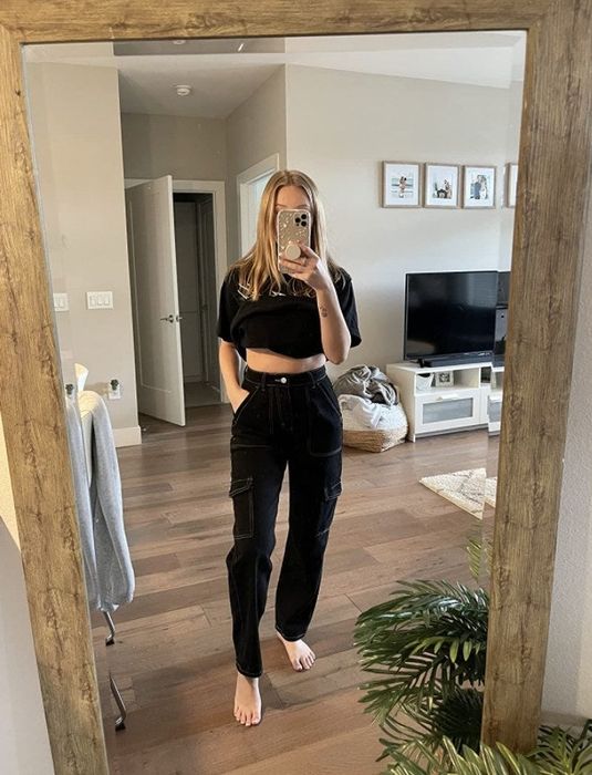 a reviewer modeling the black jeans