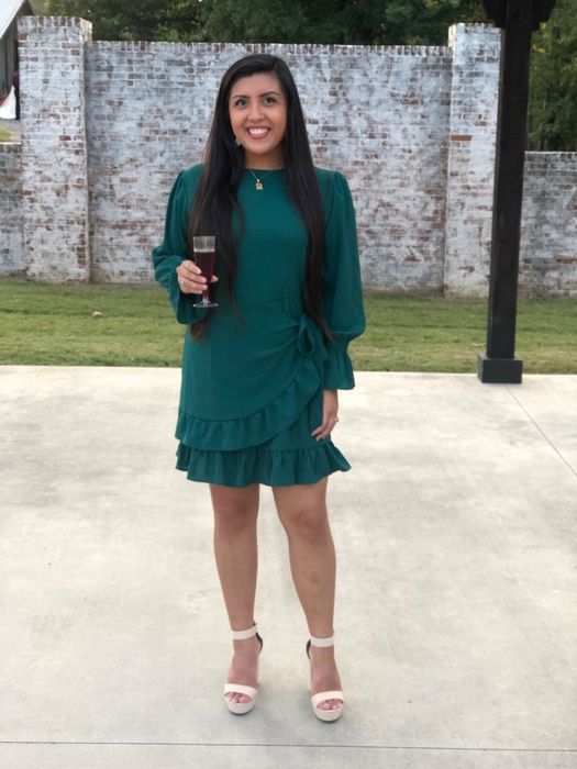 Reviewer modeling the green dress