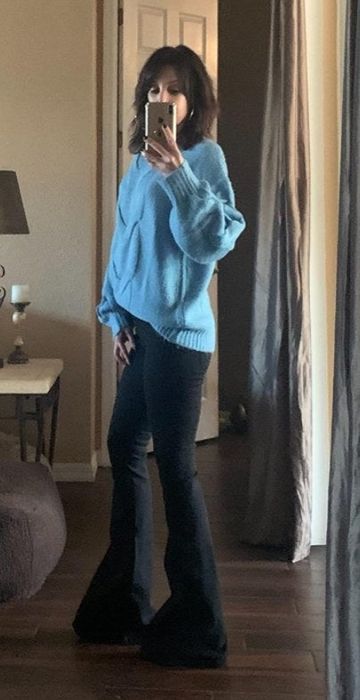 a reviewer wearing the black pull-on flare jeans