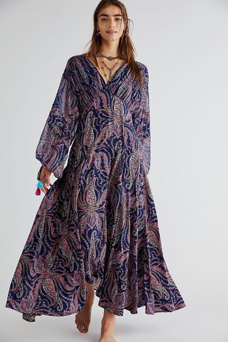 a model wearing the blue and pink patterned maxi dress