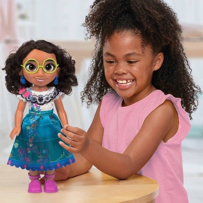 Child enjoying playtime with a Mirabel doll