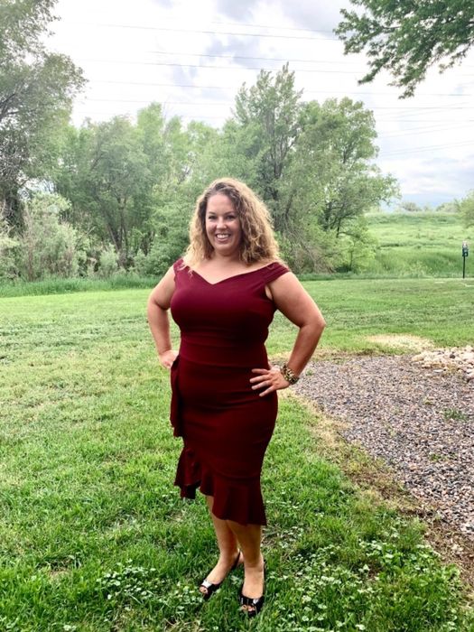 A reviewer showcasing the red version of the dress