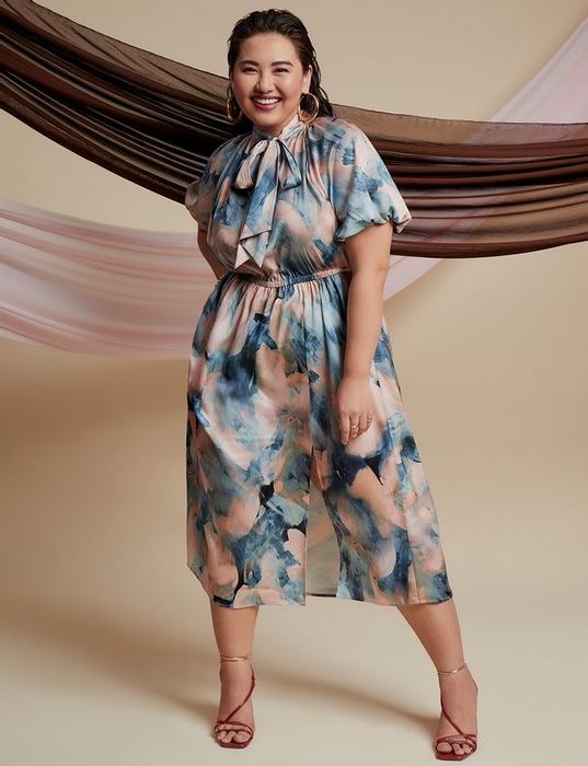 a model wearing the blue and peach marble-print dress