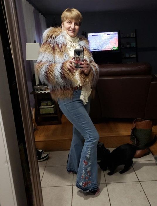 a reviewer wearing the embroidered flare jeans