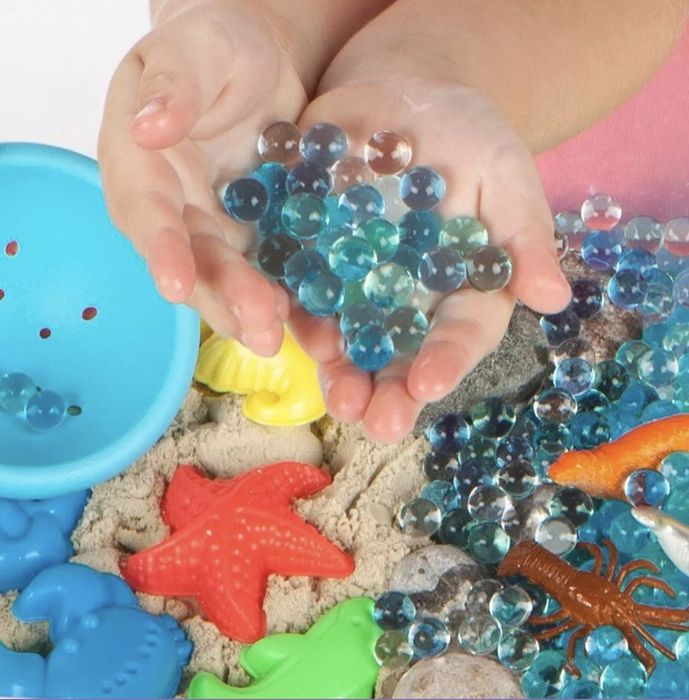 Hand holding colorful water beads