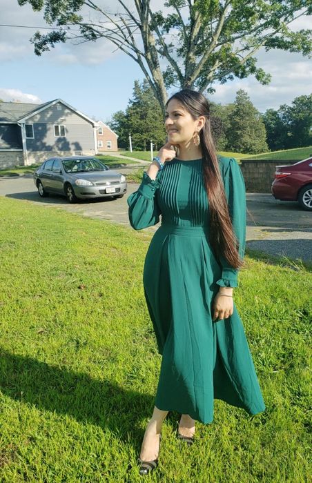a reviewer wearing the green version of the dress