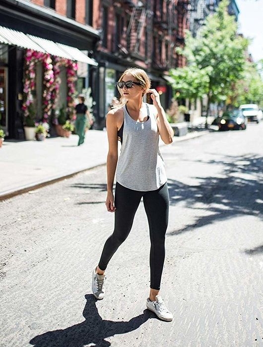 person styling the leggings with a tank top