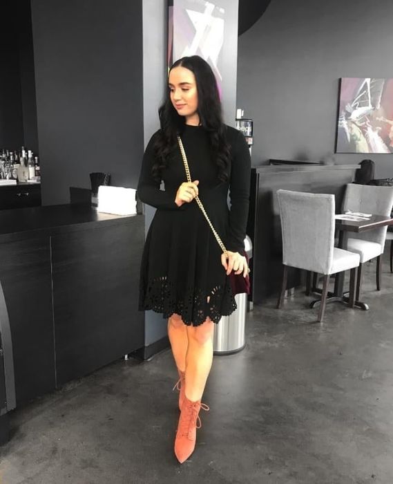 a reviewer wearing the black version of the dress
