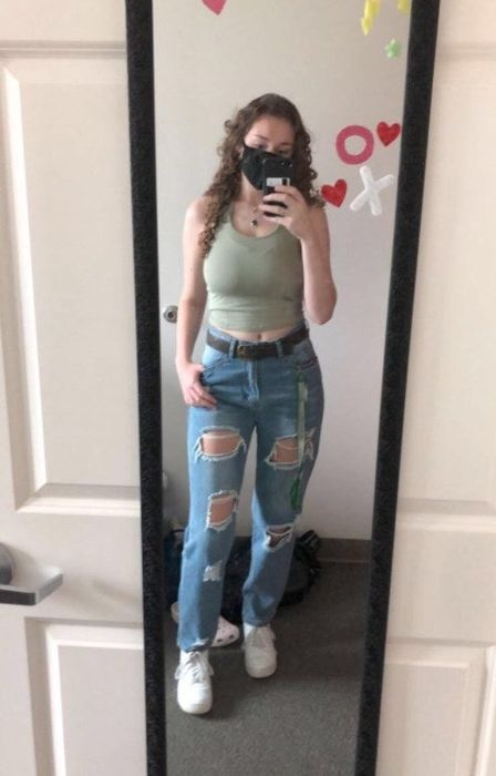 a reviewer modeling the light wash jeans