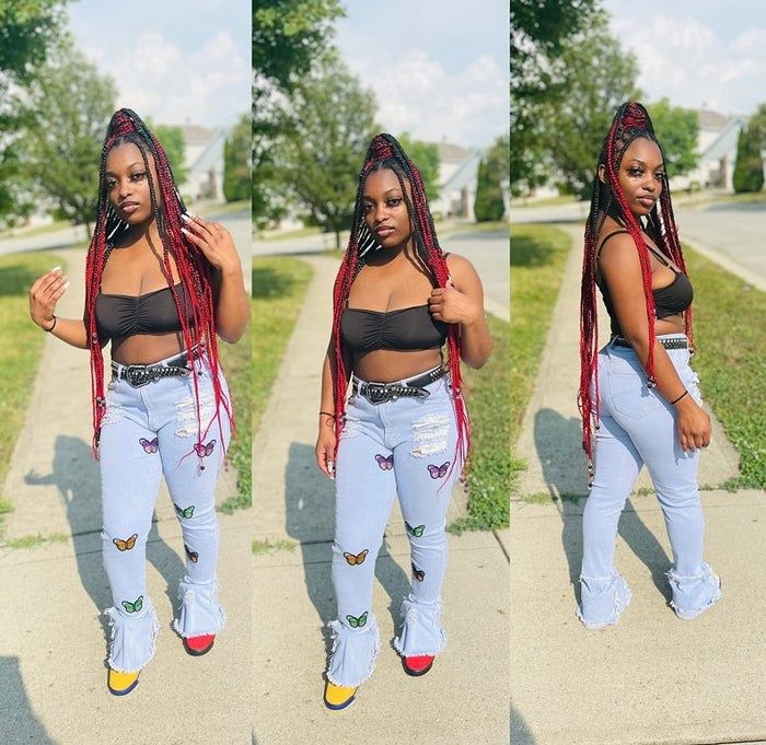 a reviewer showcasing the butterfly flare jeans