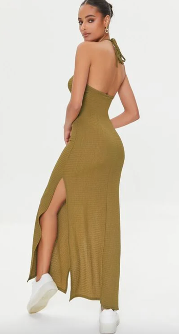 Model displaying the back of the green dress
