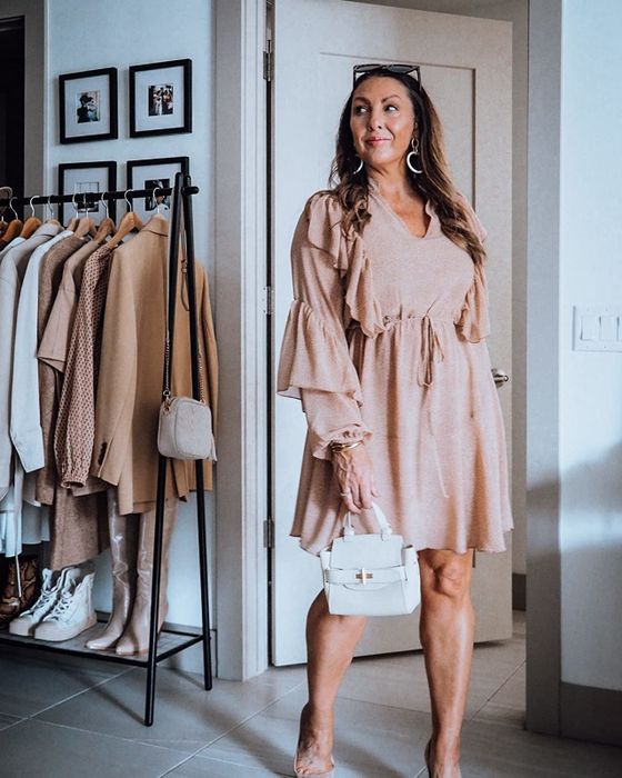 a reviewer wearing the pink version of the dress
