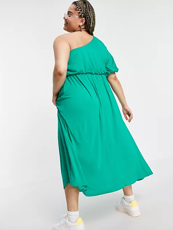 Model displaying the back of the green dress