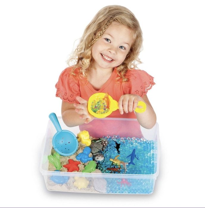 Child playing with an ocean-themed sensory kit