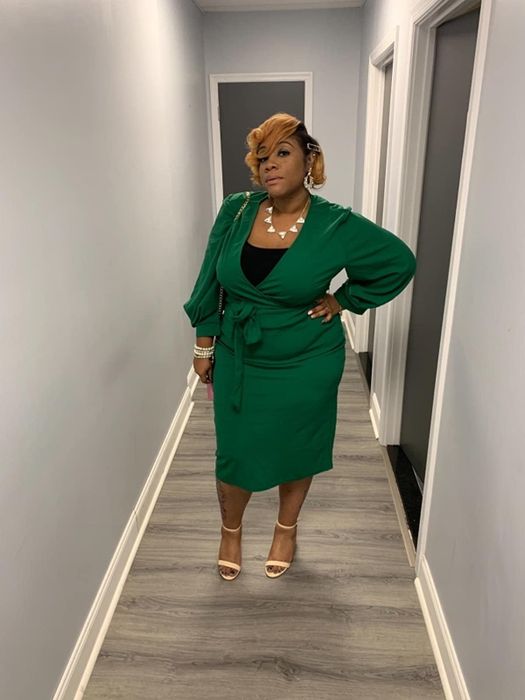 reviewer showcasing the green version of the dress