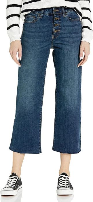 A model wearing the product with a cozy sweater and sneakers.