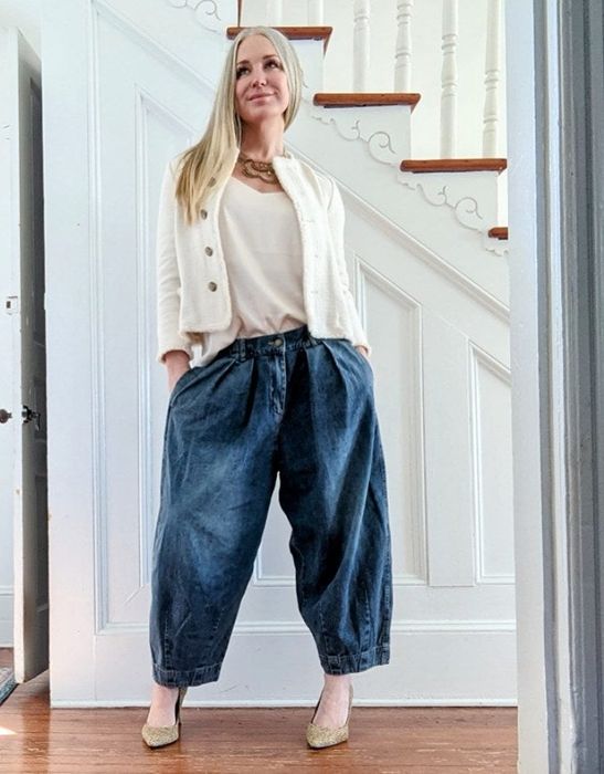a reviewer modeling the oversized denim pants