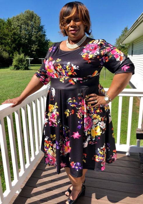 a different reviewer wearing the navy blue variation of the dress