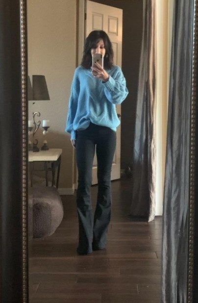 a reviewer modeling the black pull-on jeans