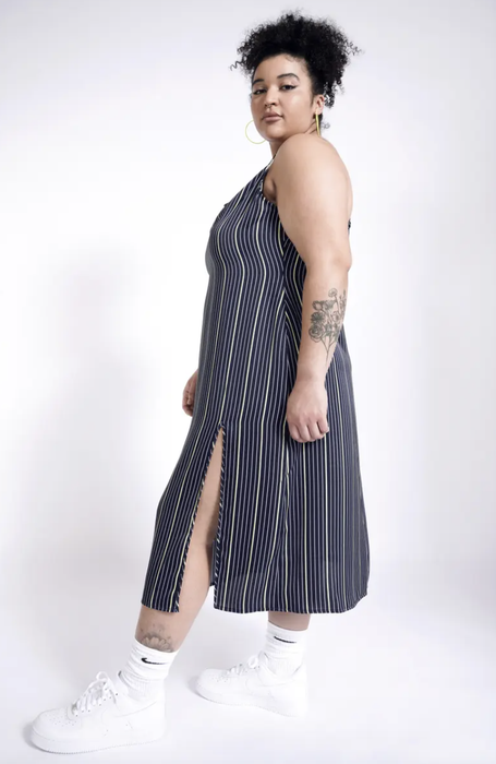 Another model showcasing the same dress, emphasizing the side slit