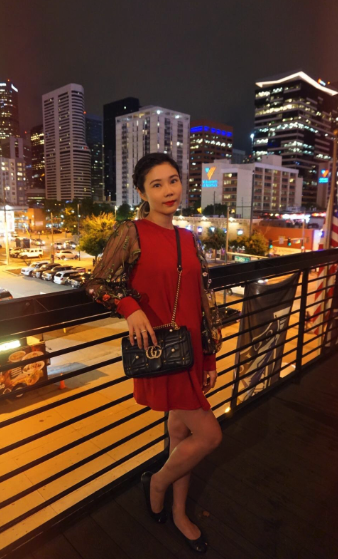 Another reviewer wearing the red version of the dress with black mesh sleeves.