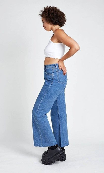 Side view of the model showcasing the product, paired with a white crop top.