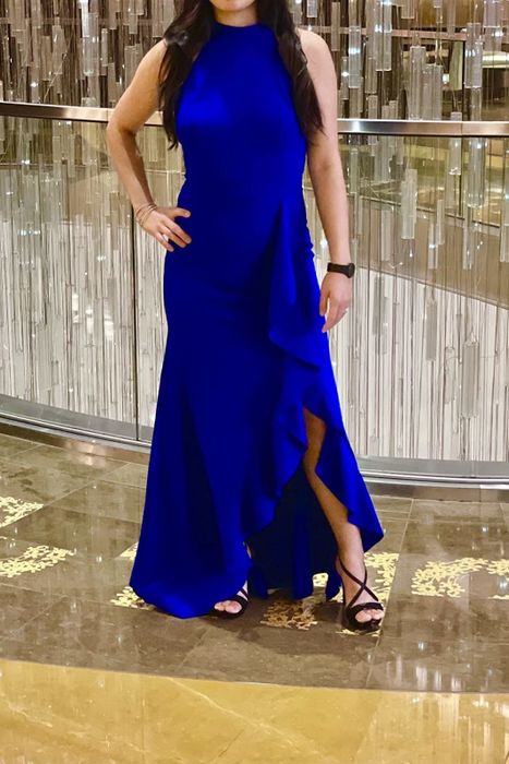 a reviewer wearing the blue version of the dress