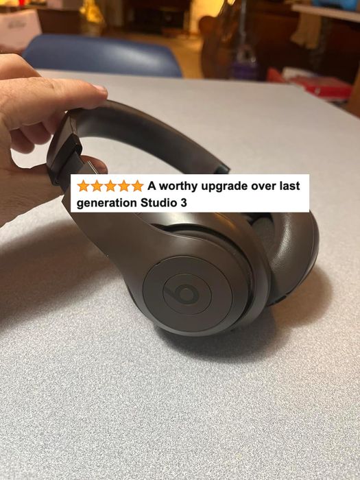 A reviewer’s grey headphones with accompanying text